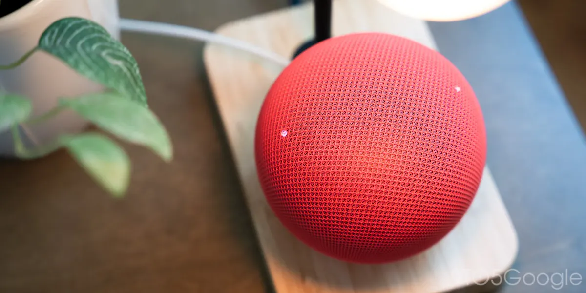 A smart speaker beside a wireless router on a table