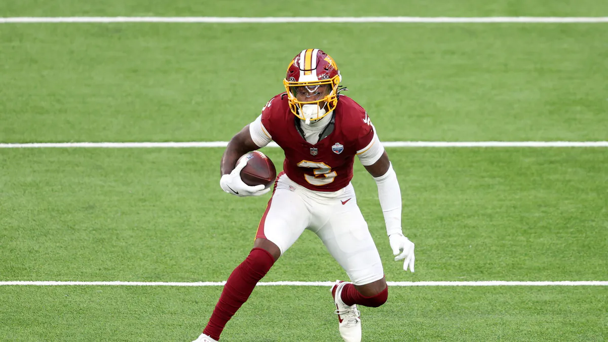 Football helmet and ball on a practice field
