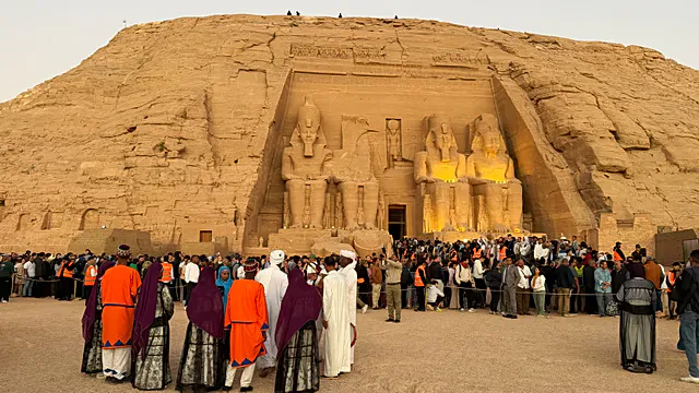 Ancient Egyptian temple facade with large stone statues