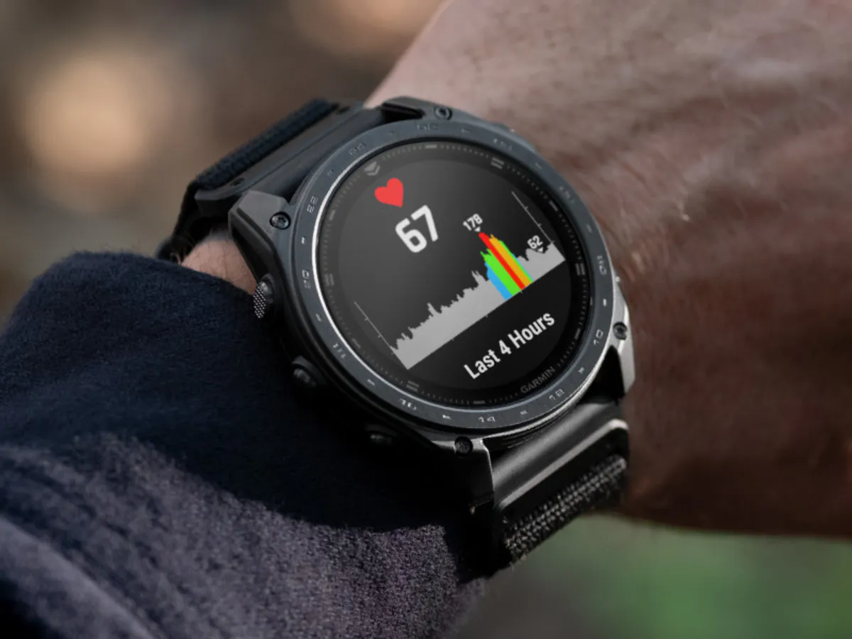 Smartwatch resting on a neutral surface beside a charging cable