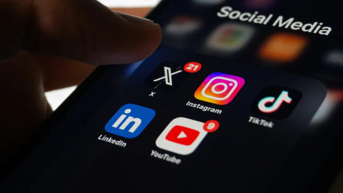 Smartphone displaying generic social media icons beside an age-verification symbol