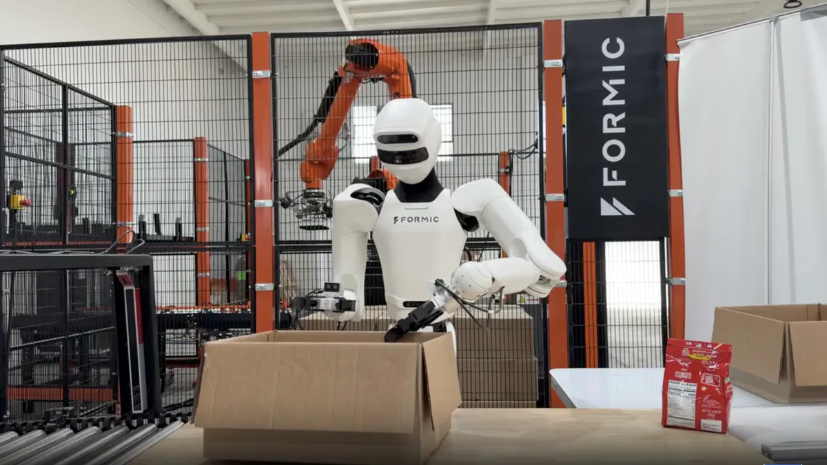 Industrial robotic arm beside a factory conveyor belt
