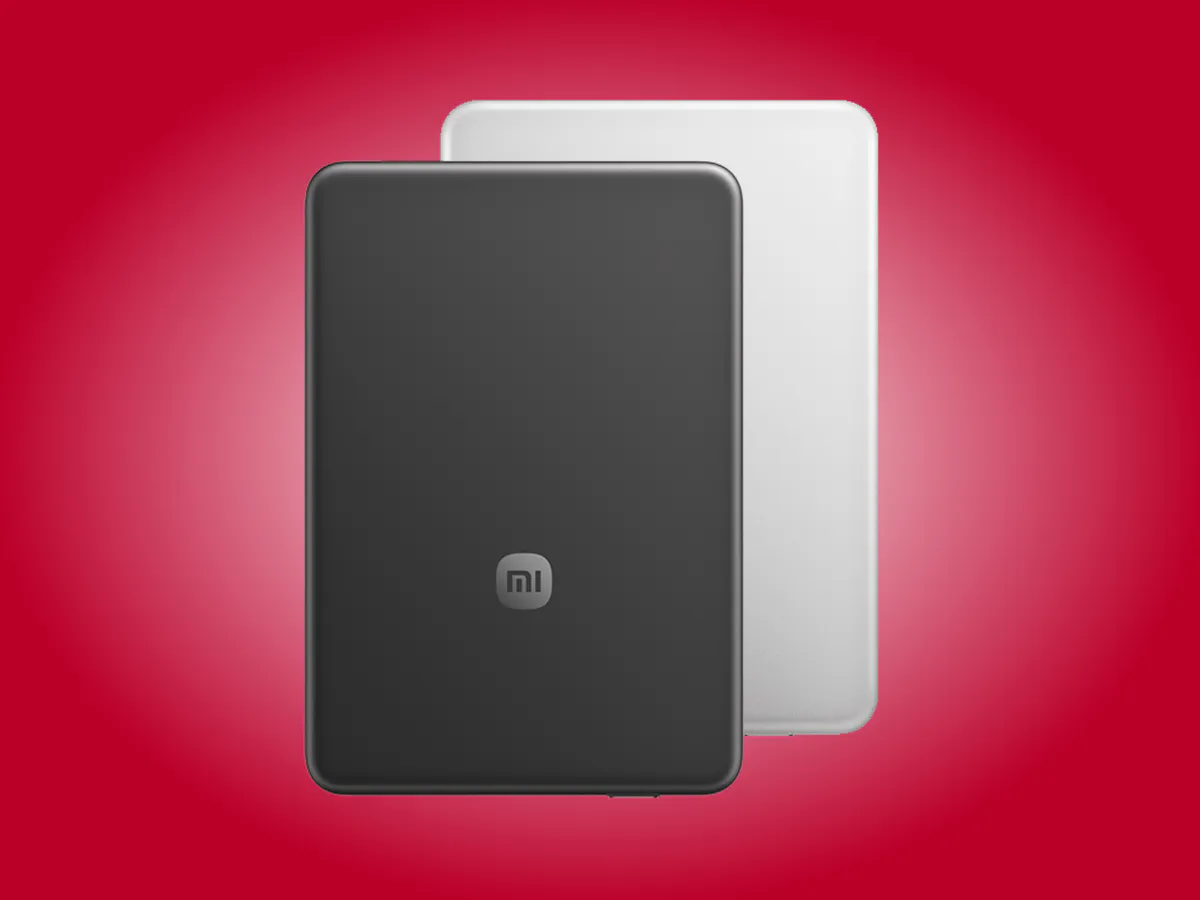 A magnetic power bank beside a smartphone on a desk