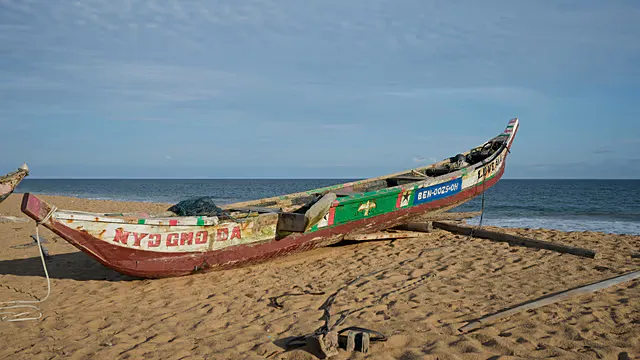 Fishing boat resting on a beach in Benin