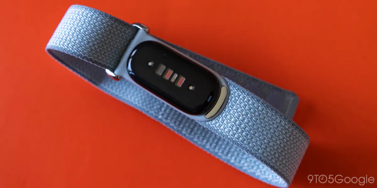 Smartwatch beside a phone displaying health tracking charts