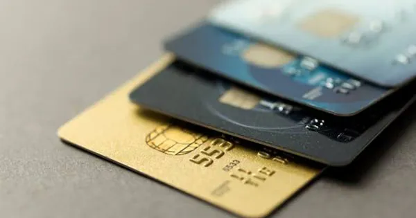 Household bills, a calculator and a credit card on a table