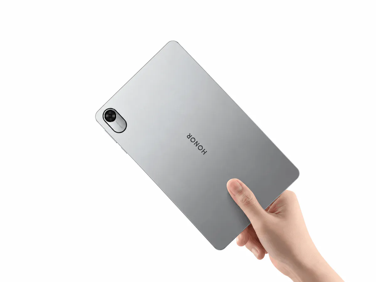 A tablet resting on a desk with its screen illuminated