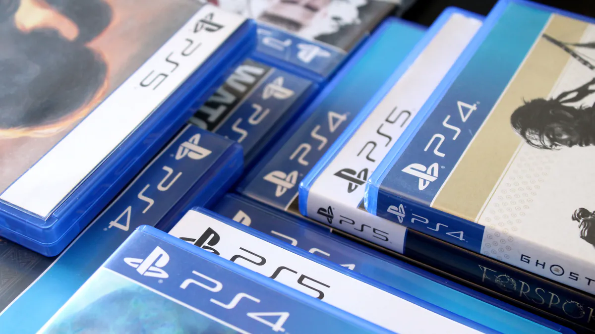 Game discs beside a video game controller
