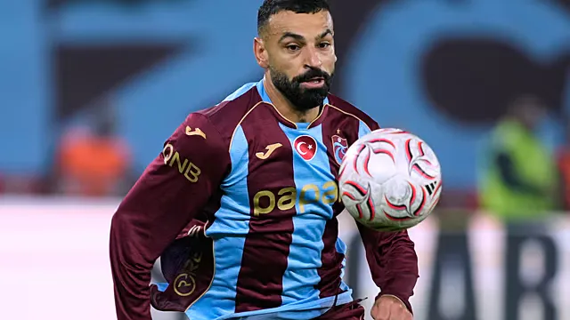 Soccer ball on a field beside maroon and light blue scarves