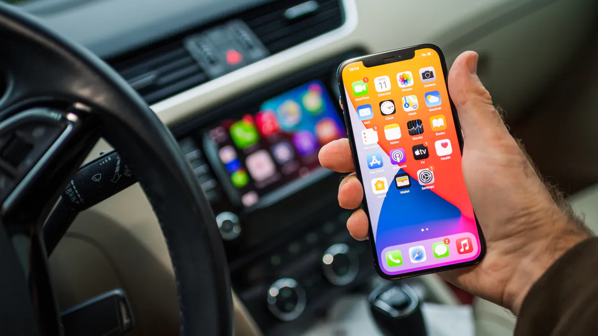Illustration of a smartphone beside a car infotainment display