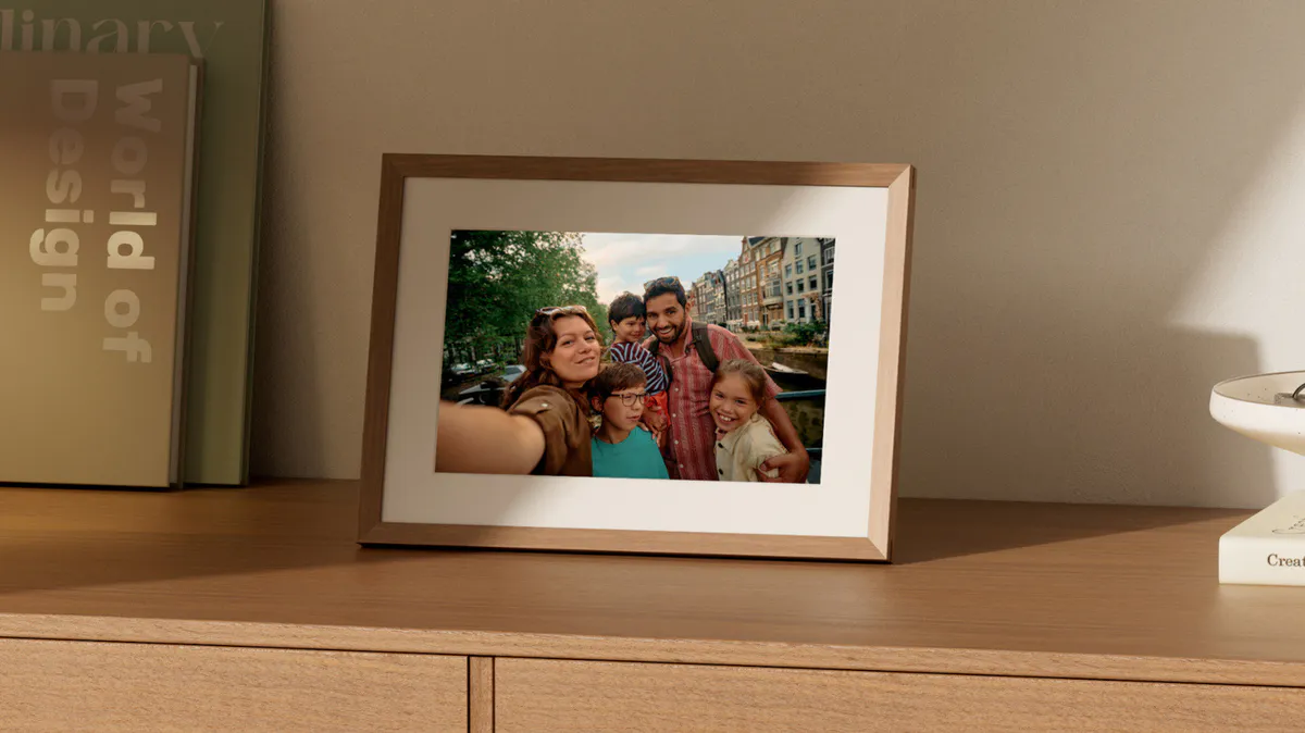 Digital photo frame displaying a landscape on a tabletop