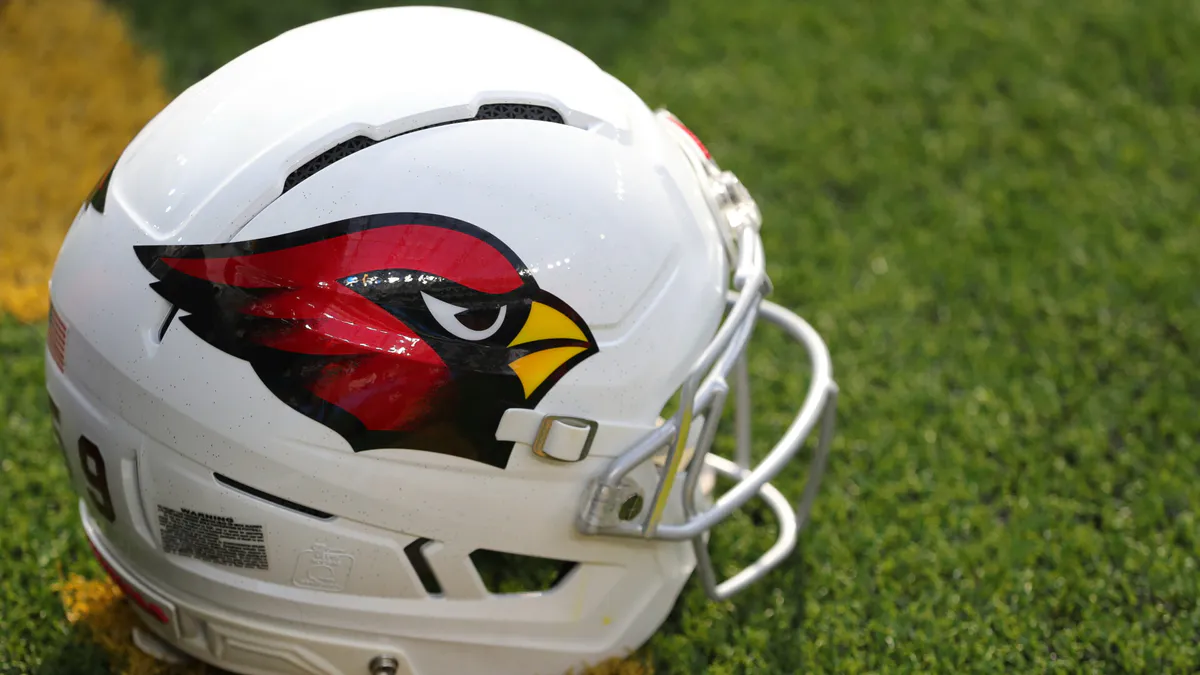 Football helmet and football beside a field