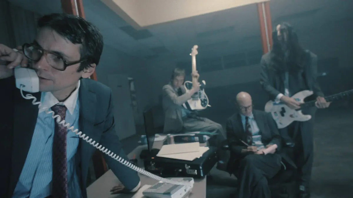 Electric guitars and microphones set up in a rehearsal room