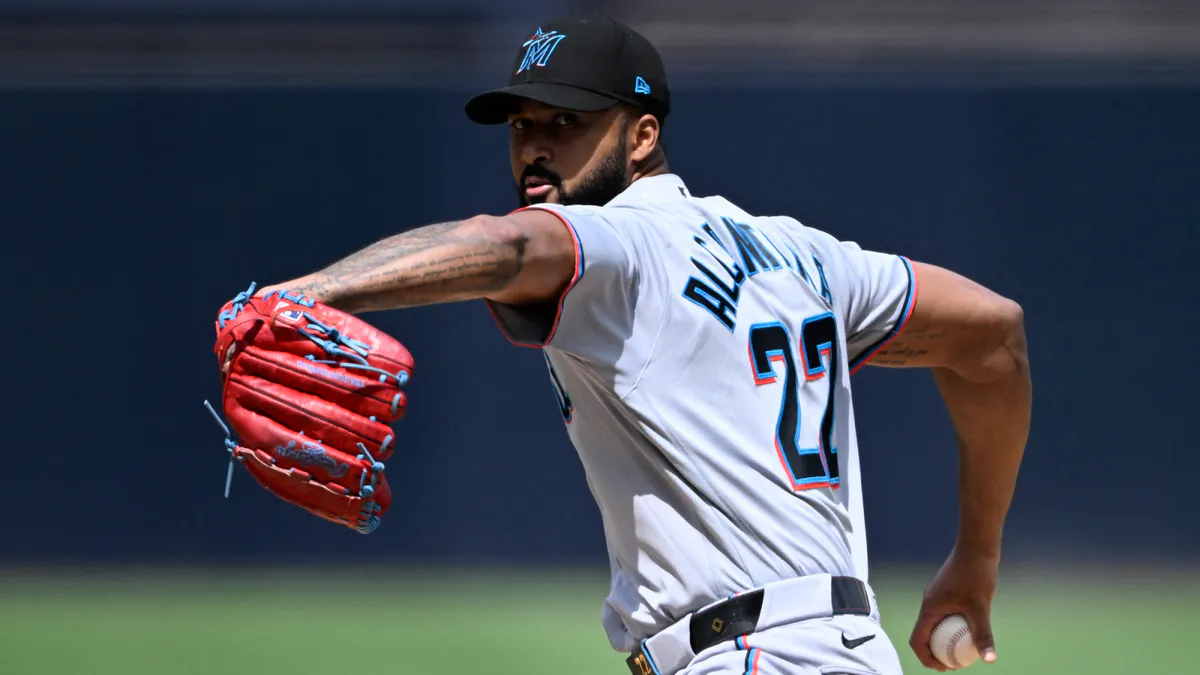 Baseball and glove resting on the dirt of a pitching mound