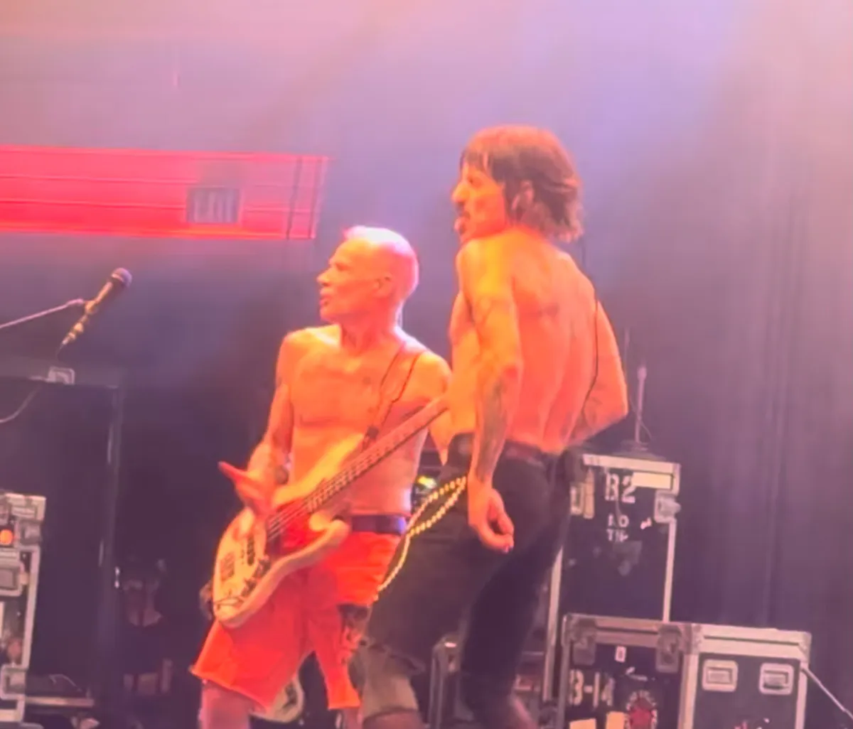 Electric guitars and a drum kit arranged on a concert stage
